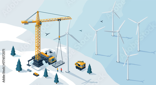 Sustainable energy construction in winter landscape with wind turbines and crane