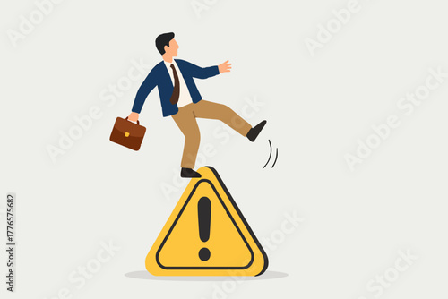 Mistake caution, business risk or problem warning, failure prevention or avoid danger concept, cautious businessman slip falling on exclamation symbol beware, careful caution sign.