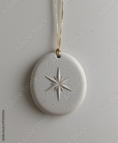 Ceramic ornament with star design hanging on the wall, minimalist style, neutral colors, copy space
