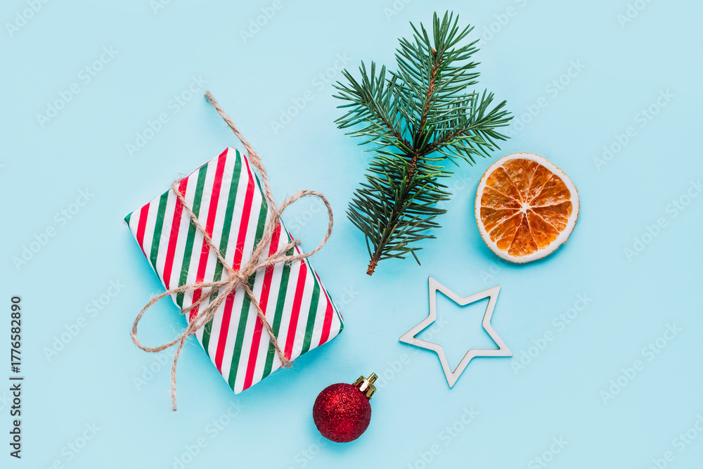 Obraz premium Collection of Christmas objects - gift box, frame, eve fir, dried orange, pine cone, star. New Year and winter minimal holiday frame composition. Flat lay, top view, place for text.
