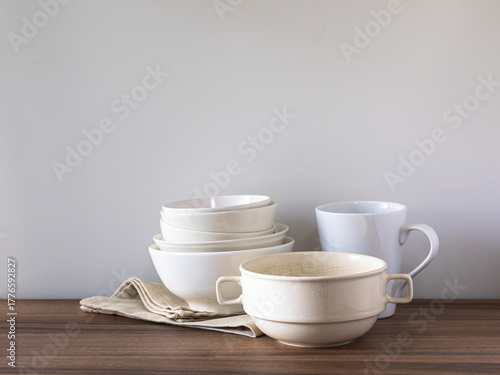 Neutral Ceramic Dinnerware Set with Linen Napkin on Wooden Table Minimal Kitchen