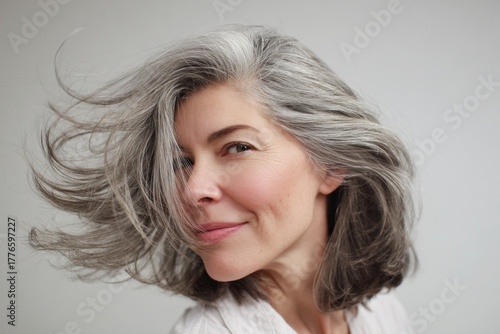 Confident Mature Woman with Grey Hair Smiling in Portrait.