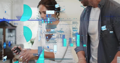 Couple preparing salad in kitchen slicing cucumber, lifting pepper grinder, causing data overlays