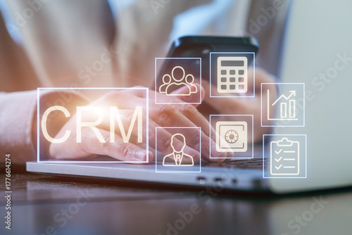 Using CRM software on a laptop for managing customer relationships in a modern office setting