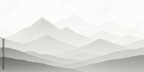 Misty morning view of a snowy mountain range landscape under a blue sky at sunrise