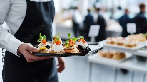 Wallpaper Mural A waiter holds a tray of appetizers at a social event. The snacks are topped with creamy toppings, herbs, and caviar, promising a delightful culinary experience for attendees. Torontodigital.ca