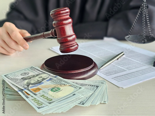 Courtroom scene with a judge's gavel beside cash and legal documents during a trial in a modern legal