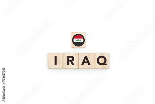 Wooden blocks bearing the name and flag of Iraq. Iraqi and Persian Culture, national identity, travel, and geography in an advertising space design.