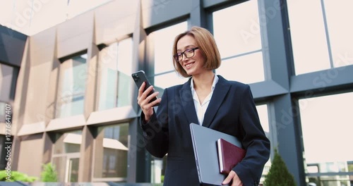 Wallpaper Mural Portrait of businesswoman office employee using smartphone against commercial building outdoor. Man working on mobile cell phone. Torontodigital.ca