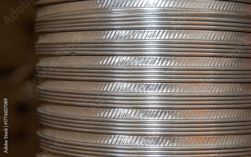 shiny currency with textured edges, bright stacked coins with reflective surfaces capturing light