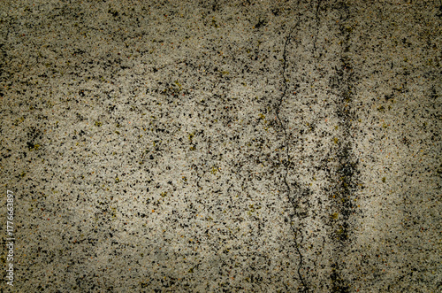 Detail of a textured surface showcasing unique patterns created by mineral deposits and natural elements, revealing a combination of earthy colors and textures. Copy space. 