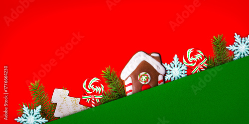 Festive decorations include a gingerbread house, candy canes, and snowflakes, creating a colorful holiday scene with vibrant red and green colors. Copy space for greeting text. 