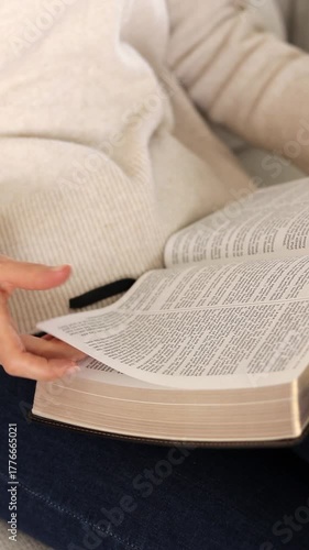 Christian woman is reading holy bible book. Vertical video. Morning Scripture study, biblical concept.