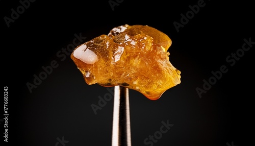 live rosin on a dab tool with a black background