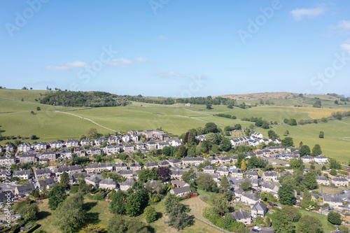 Aerial photo of the town of Kendal which is a market town and civil parish in the unitary authority of Westmorland and Furness, England showing housing estates and streets on a bright sunny day