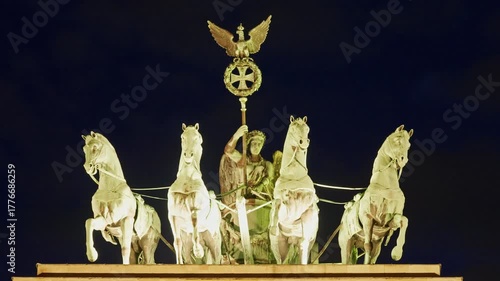 Berlin, Germany -15.08.2025: Quadriga statue on Brandenburg Gate with illumination in the evening, Berlin. Germany