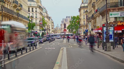 France, Paris, 25.08.2025: French street Rivoli in centre Paris with cars, people and cyclists. City traffic in the city center. Timelapse