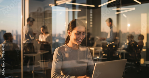 Modern corporate office with employees collaborating in a glass walled meeting room as warm sunlight creates an inspiring, professional atmosphere.
