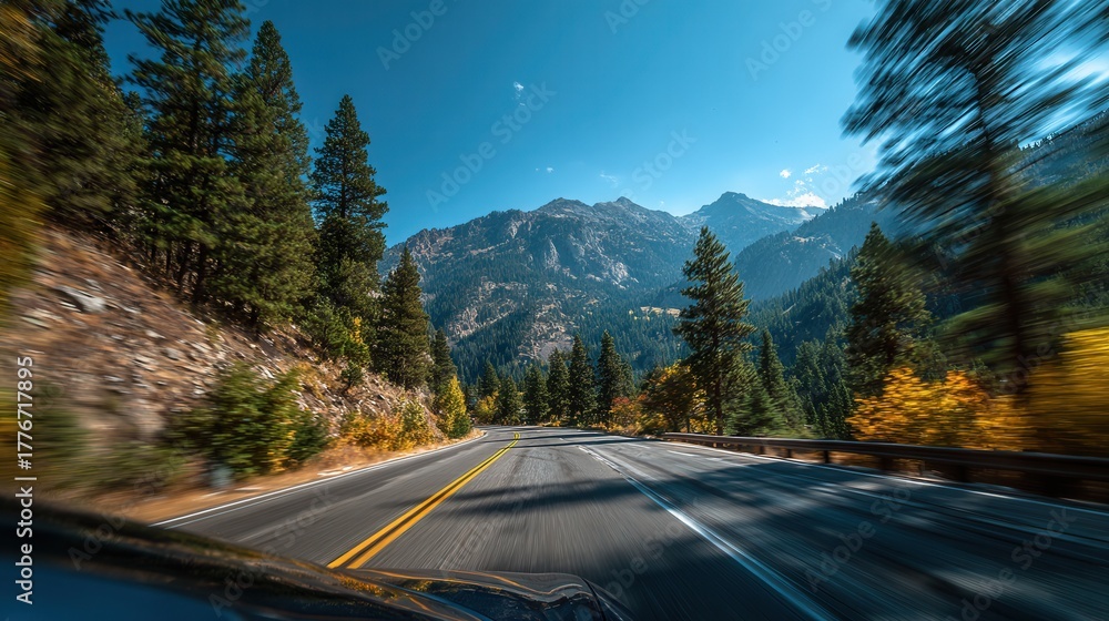 Fototapeta premium Driving view on forest highway with distant mountains and motion blur