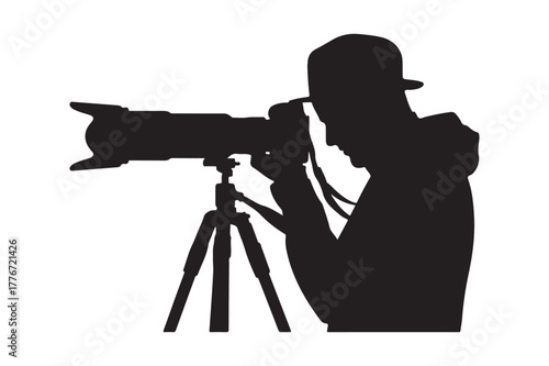 Silhouette of a photographer with a large lens on a tripod
