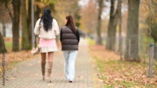 young woman walking in autumn park
