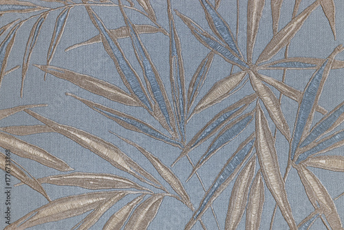 Elegant bamboo leaf wallcovering on muted blue with metallic botanical pattern