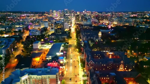 Nashville, TN - October 24, 2025: Nashville skyline at night, looking down Broadway, with Vanderbilt in foreground.