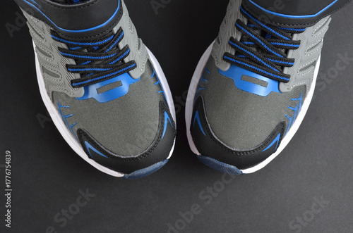 Gray-blue sneakers on a gray background.