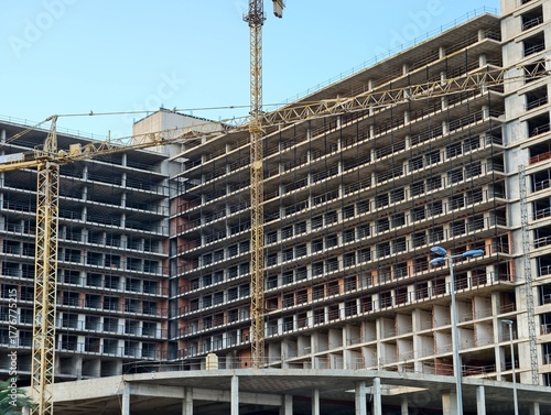 ongoing building with safety emphasis, active construction showing structural details and safety