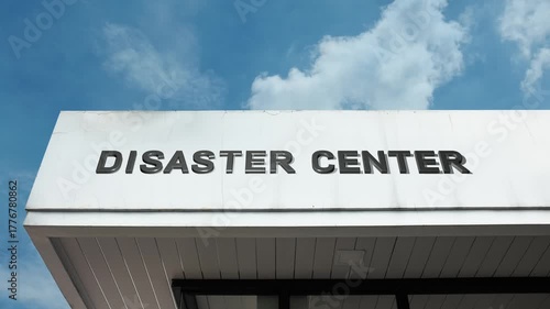 Disaster Center word sign displayed on building facade with clear blue sky, highlighting a facility focused on emergency response, relief services, and disaster management