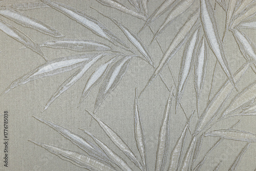 Embossed bamboo leaves on metallic fabric, neutral beige tapestry background