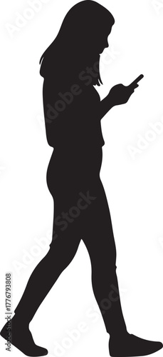 Silhouette of a woman walking outdoors while looking down at her smartphone screen device side view