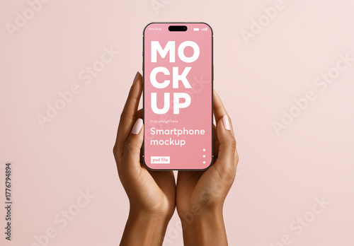 Smartphone mockup held in hands on pastel background