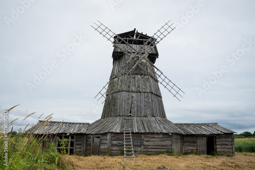Rustic Wooden Windmill in Countryside Landscape