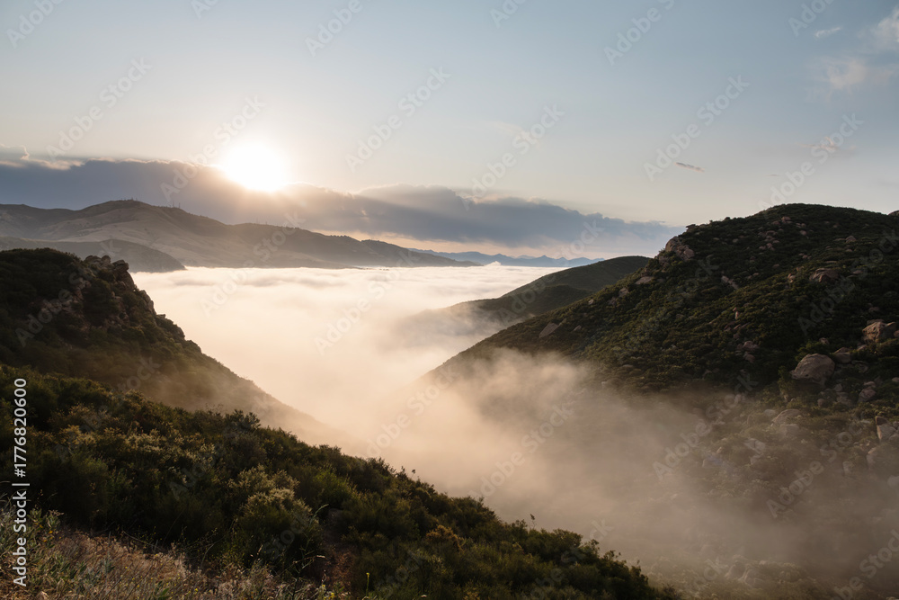 Fototapeta premium Hilltop view of flowing morning fog in the Porter Ranch and Chatsworth area of Los Angeles California.