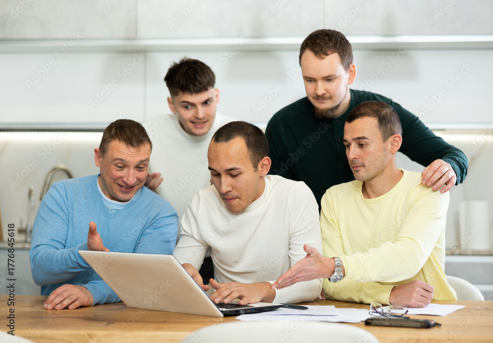 Fototapeta premium Group of friends watching funny comedy movie on laptop indoors