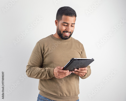 Smiling Man Using Digital Tablet