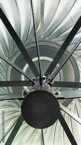 A view from inside an air duct showing a rotating deflector and stainless steel grille in a ventilation system design for an industrial restaurant building.
