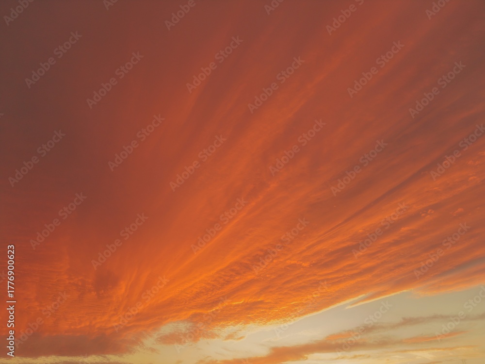 Fototapeta premium Fiery Orange and Red Sunset Cloud Texture Background
