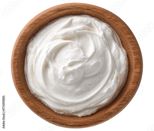Creamy, white yogurt or sour cream in a wooden bowl