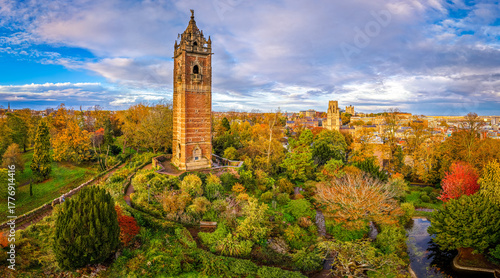 Cabot Tower surrounded by colorful autumn trees in Brandon Hill Park, with historic Bristol architecture in the background.