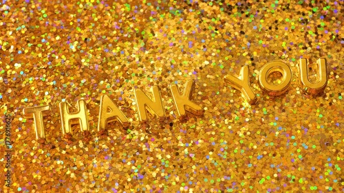 thank you on gold glitter background.Thank you for the message.The inscription Thank you in gold letters with gold highlights on a gold background. 4k footage