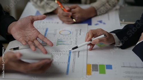 Business team analyzing financial data charts together