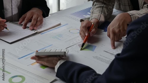 Business team analyzing financial charts during meeting