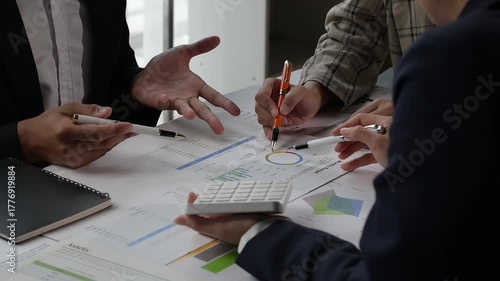 Business team analyzing financial data and graphs