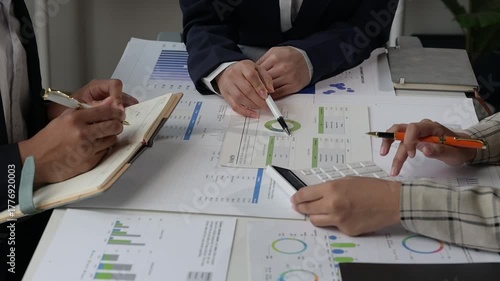 Business team analyzing financial data charts and graphs