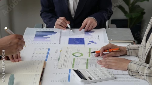 Business people analyzing financial charts during meeting