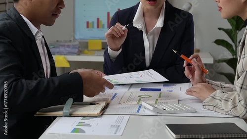 Business team analyzing financial data charts and graphs