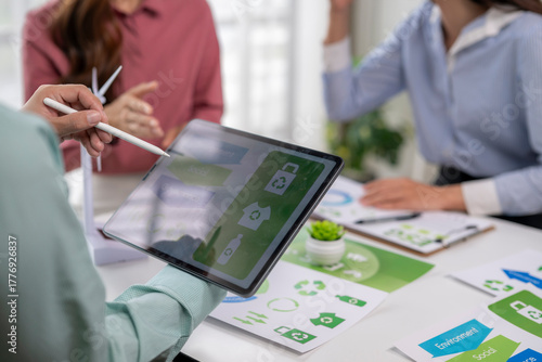 Business people planning sustainable energy project using tablet