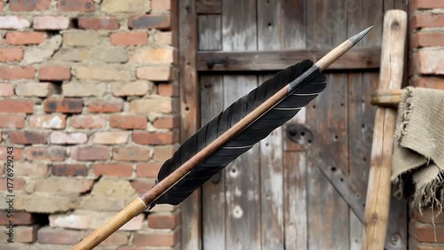 traditionally crafted projectile with a straight shaft  a sharpened point  and stabilizing fletching at the rear end  designed for launch from a